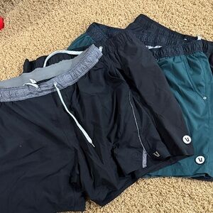 Four pair of Vuori Men's Athletic Shorts - Black and Teal